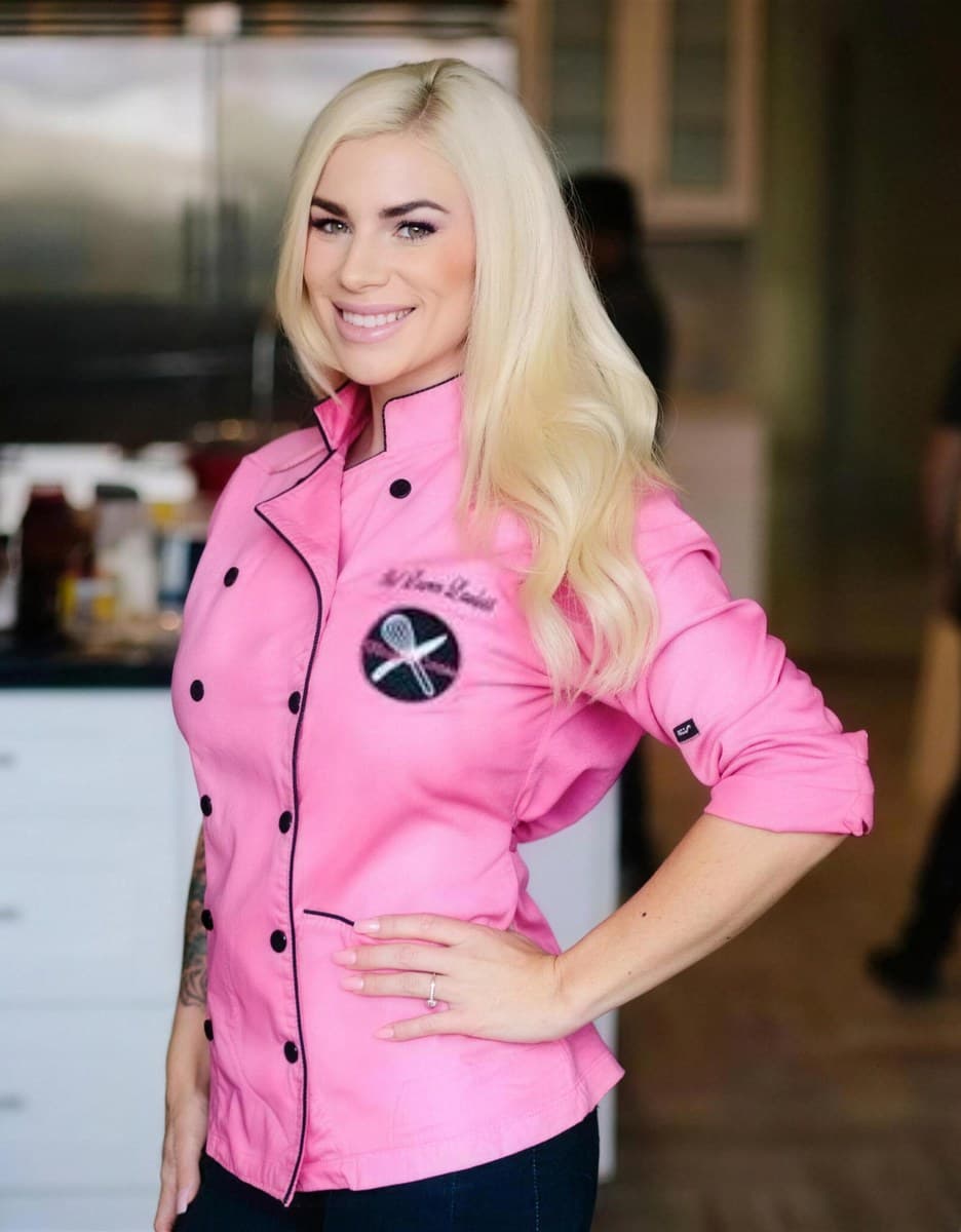 Chef Lauren Lawless in her pink chef coat, smiling in a home kitchen